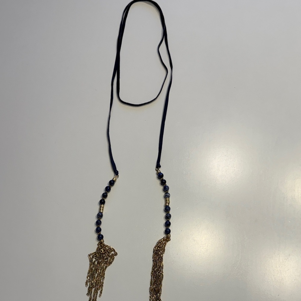 Necklace.  Navy ribbon with navy blue stones at the end and gold tone tassels.